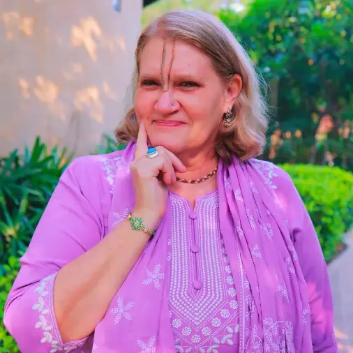 Dr. Joshi, PhD, Vedic Psychology teacher in purple attire, illuminating the mind and awakening the heart.