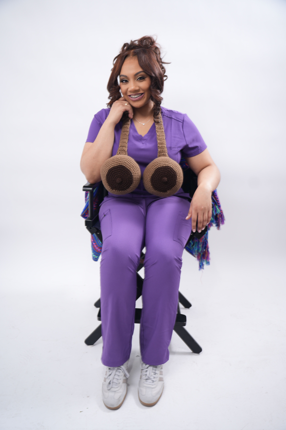 Image of Chanel Washington sitting in chair with lactation education props