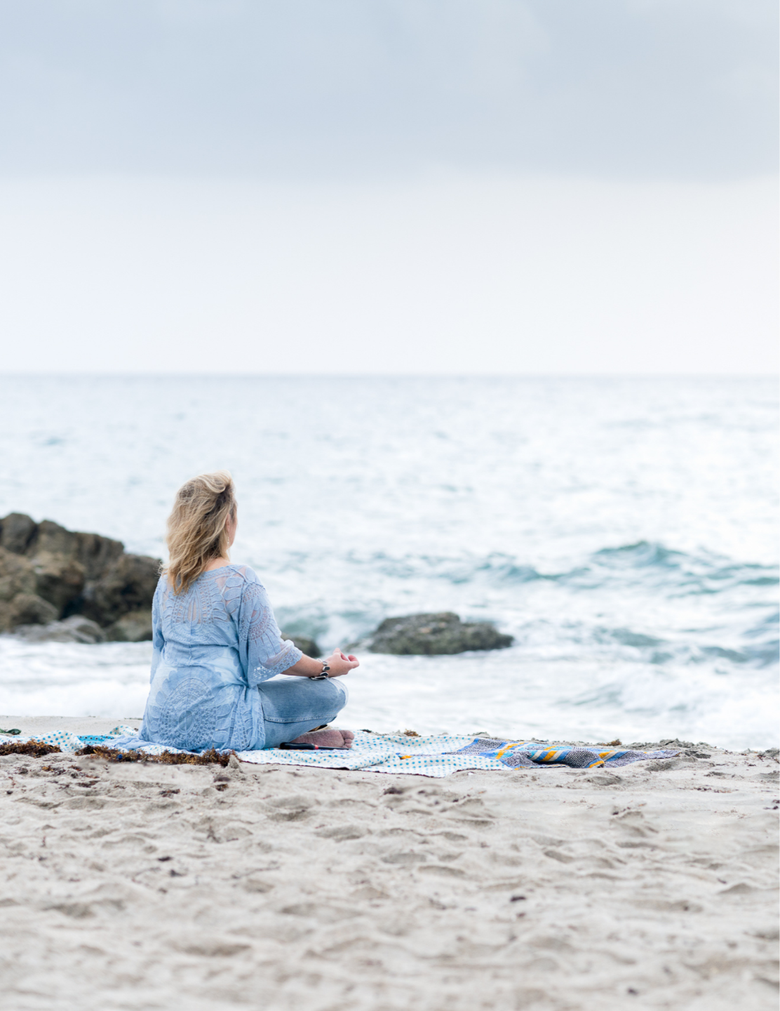 person facing sunrise hands in yoga position fingers touching