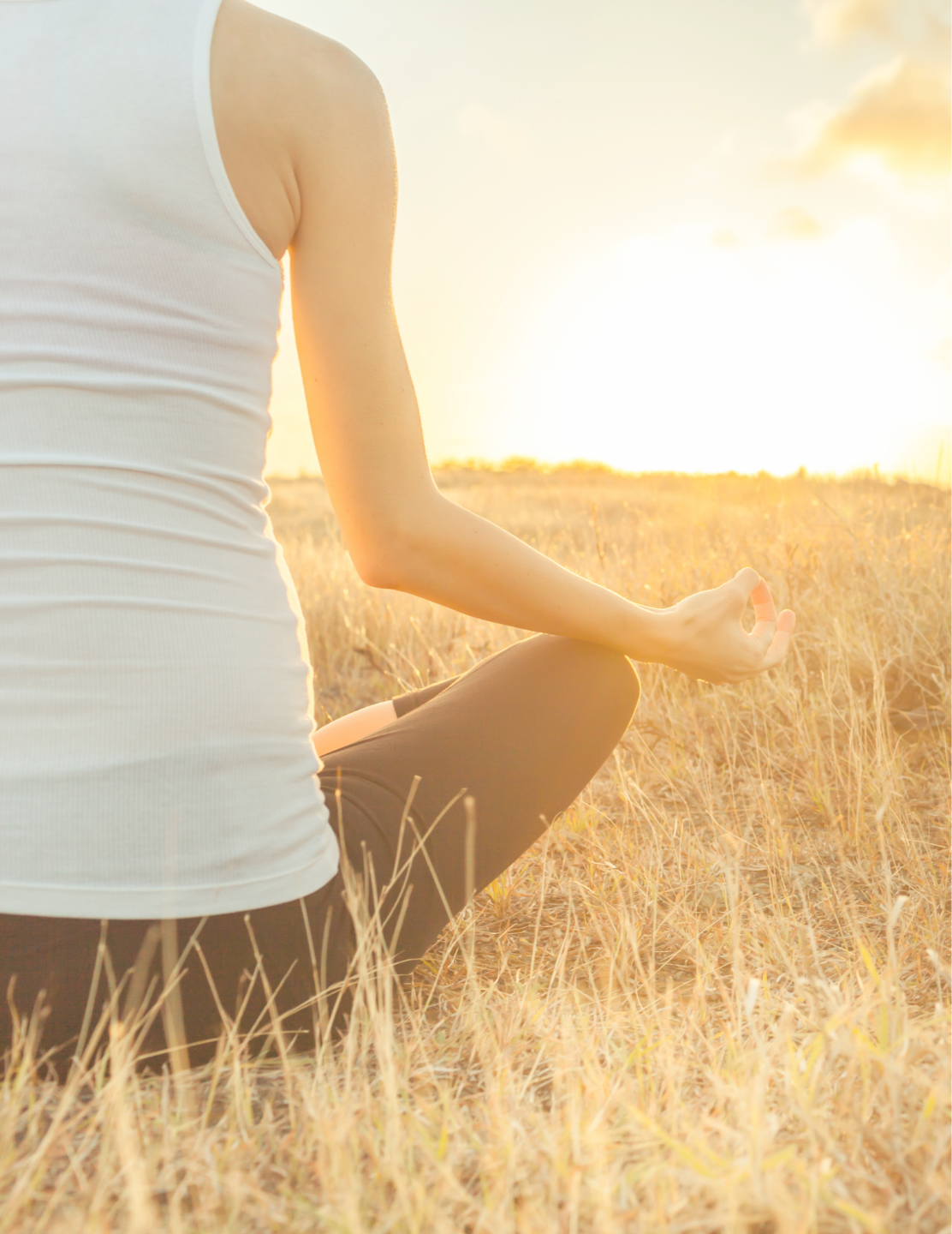 person facing sunrise hands in yoga position fingers touching