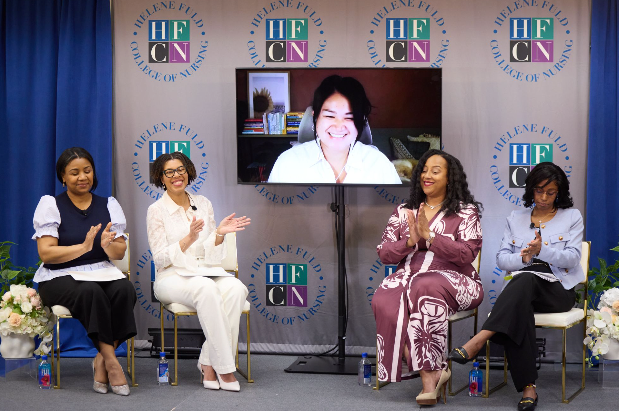 April speaking in pink suit