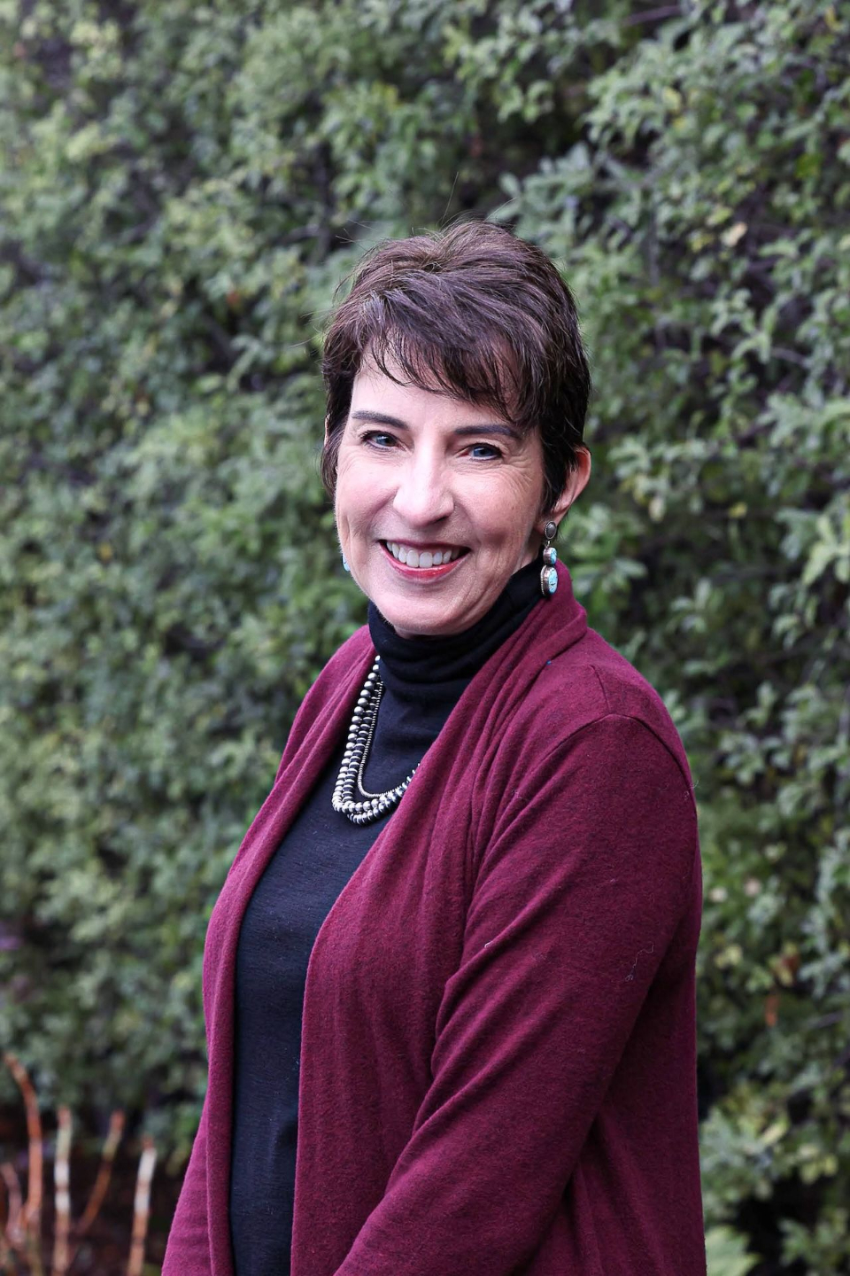 Anne-Rosales-headshot-dark-red-cardigan-close