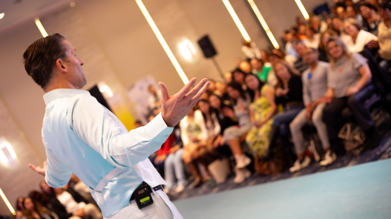 Dr. Dain Heer with audience at live event