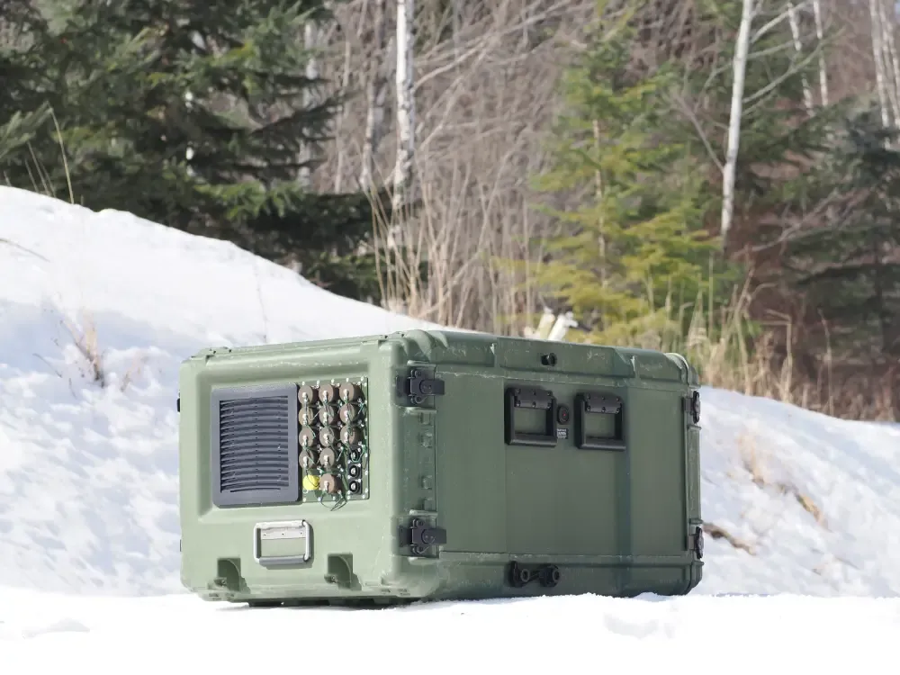 Green equipment case during a field deployment in snowy conditions.