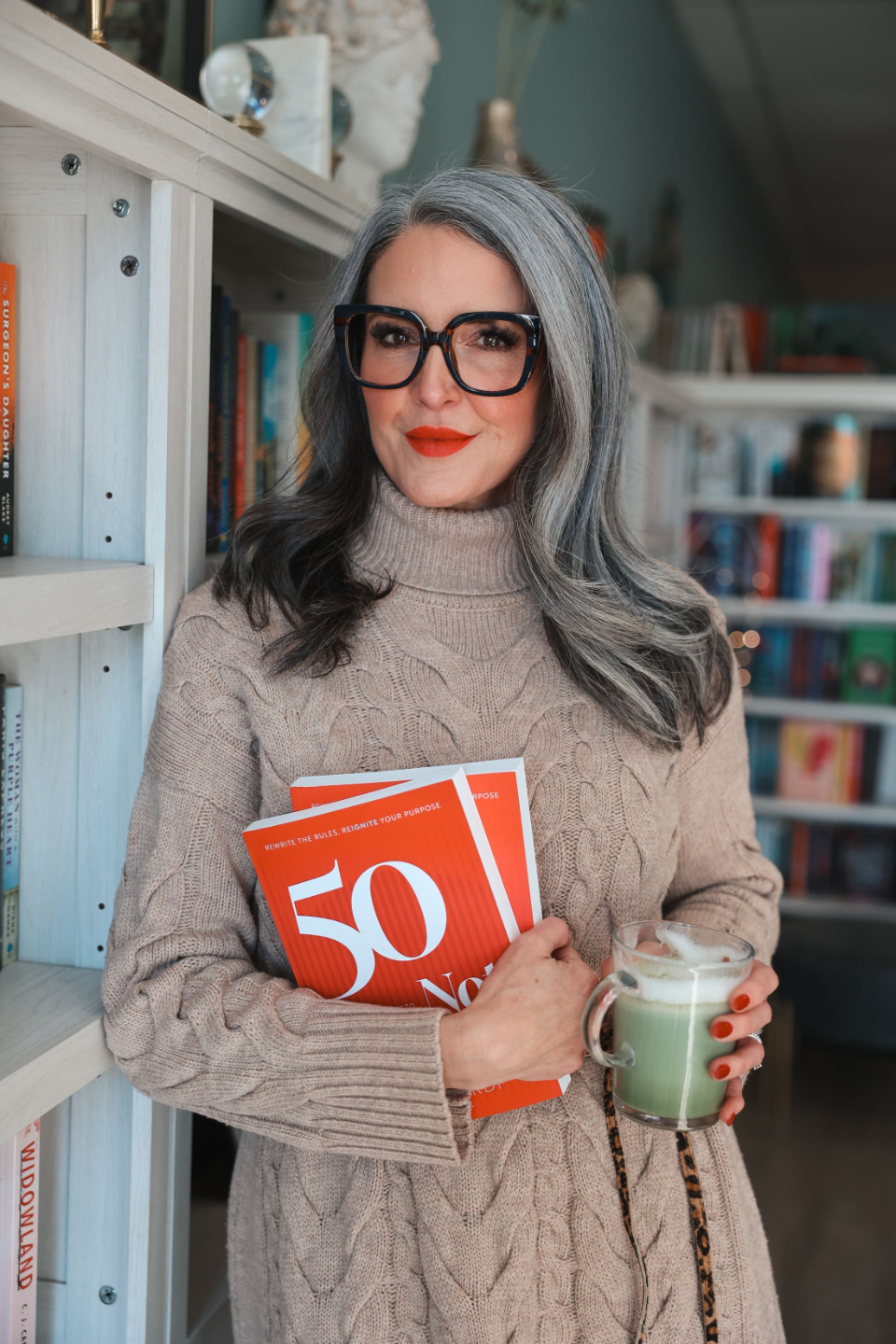 Julie Ciardi holding her book 50 Not Finished