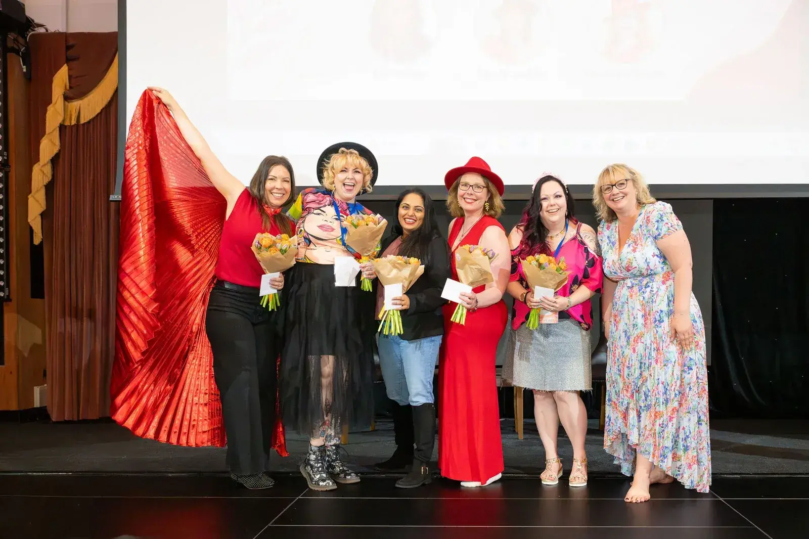 Women celebrating together on stage