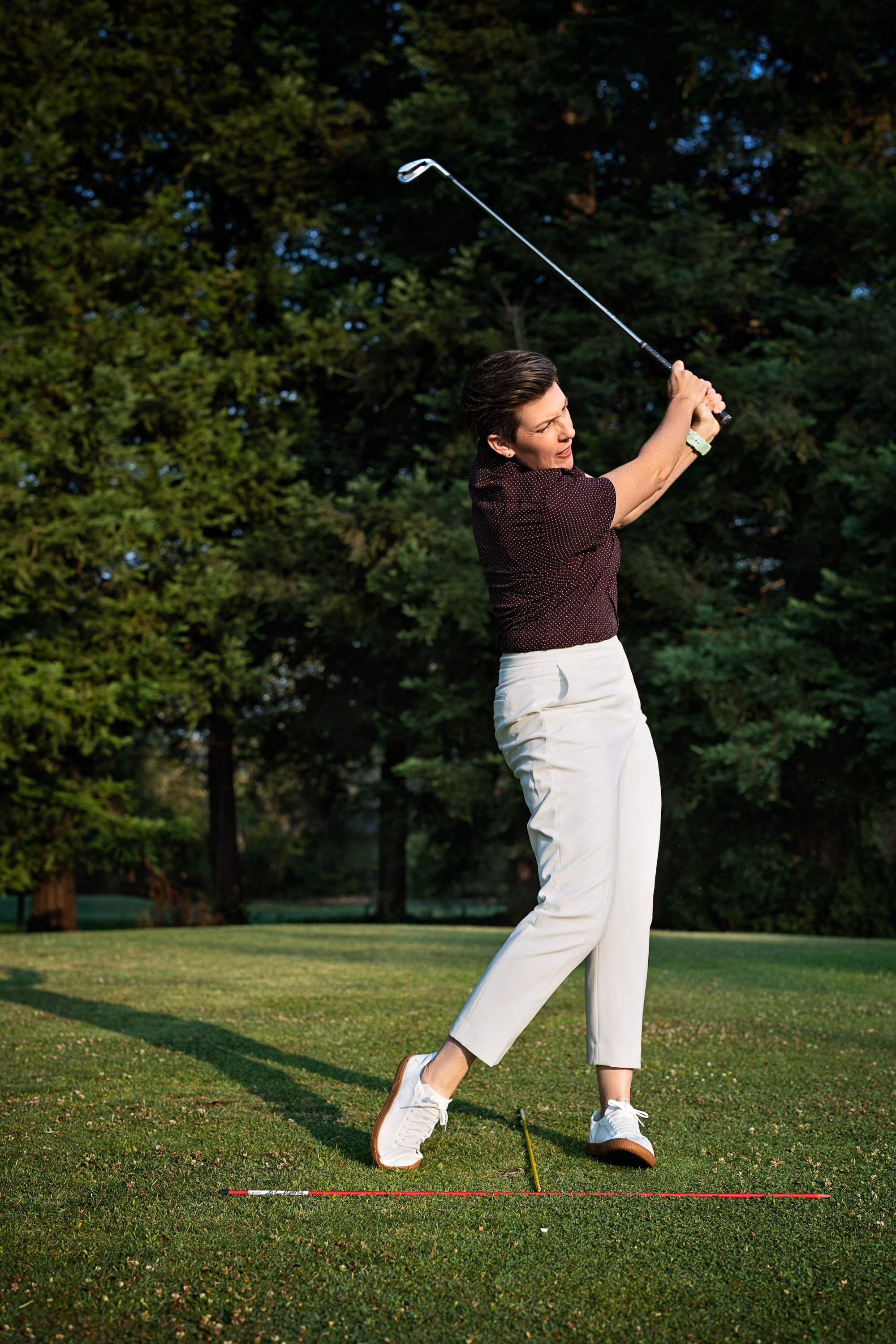 Amanda Beeler finishing an iron swing on the practice range