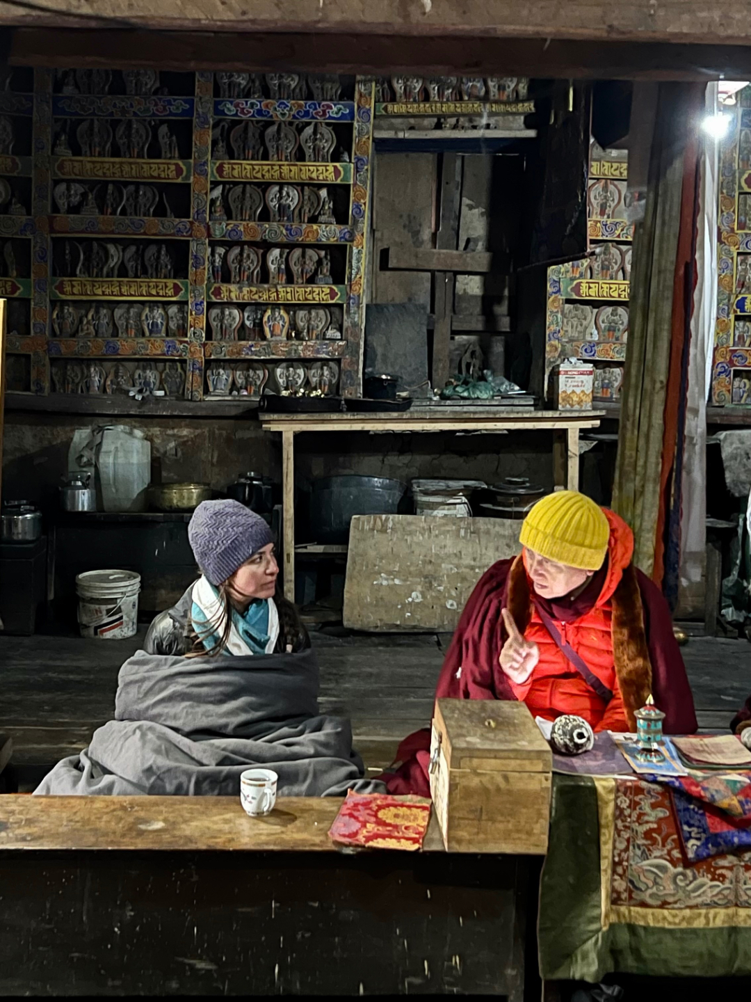 Geshe Tenzin Zopa and a pilgrim sitting together inside Mu Monastery, Tsum Valley, Nepal