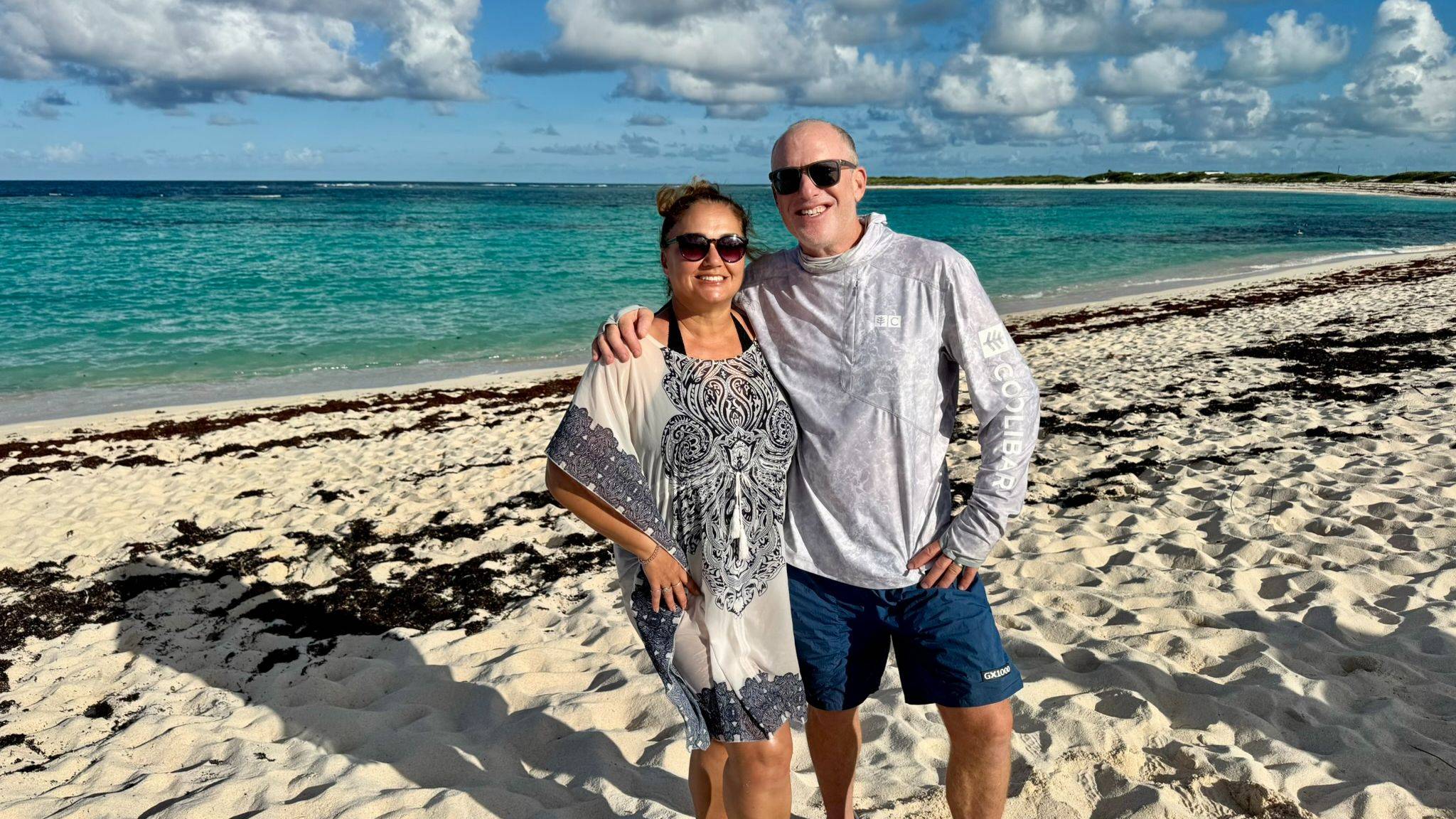A couple on the beaches of the British Virgin Islands during a learning catamaran sailing vacation