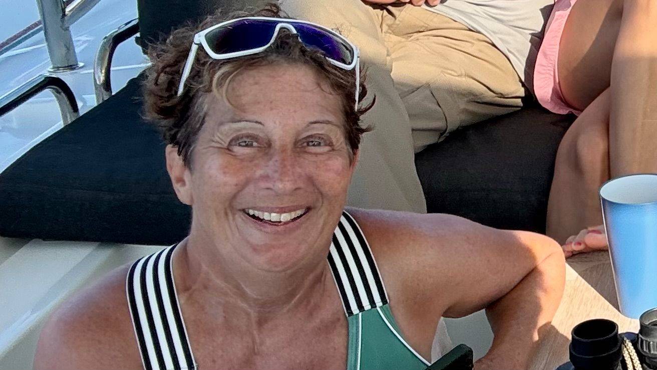 A middle aged solo female traveler sailing in Sea of Cortez Mexico