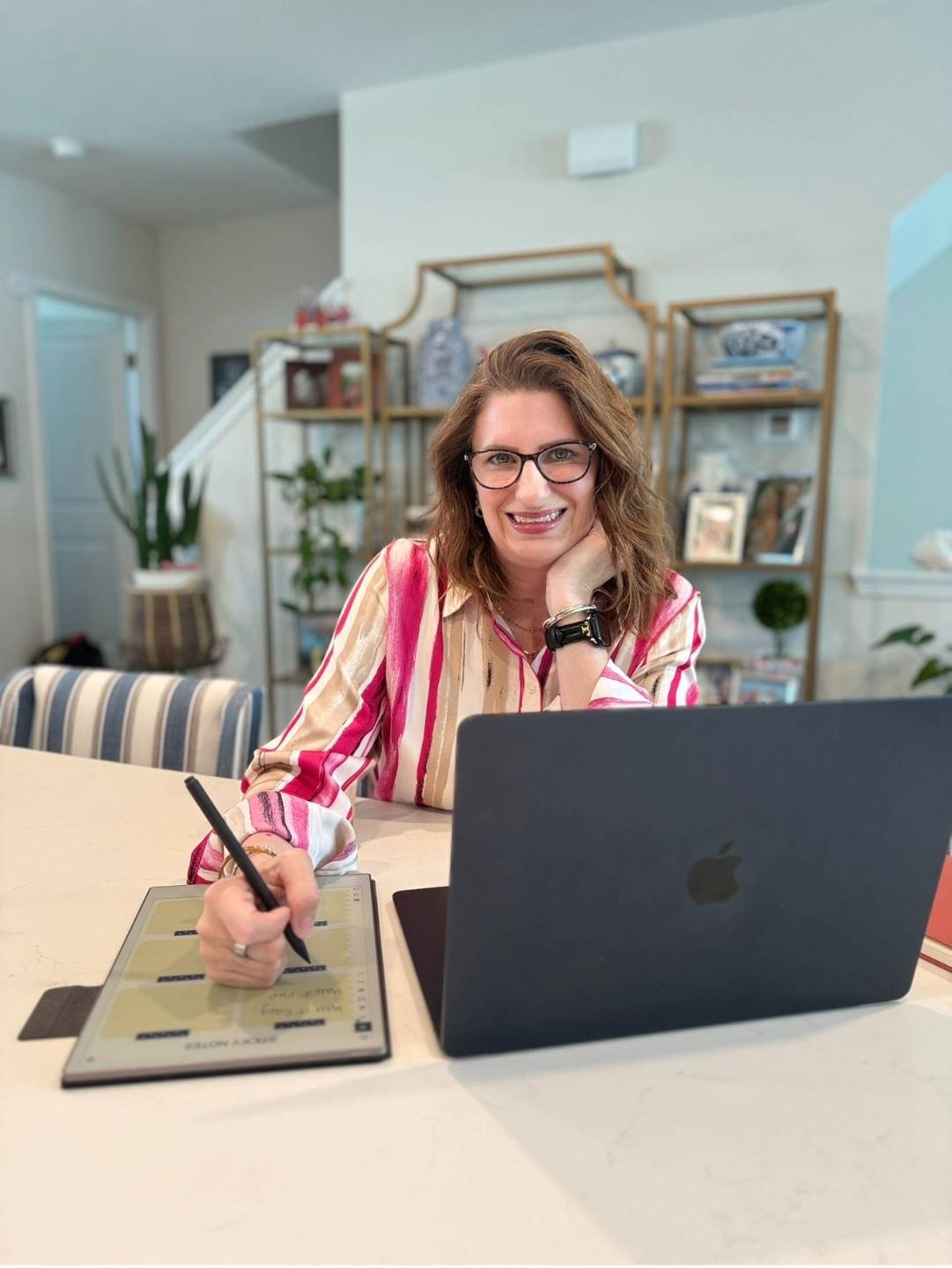 Sara Ritchie working at her desk, creator of From Curious to Confident