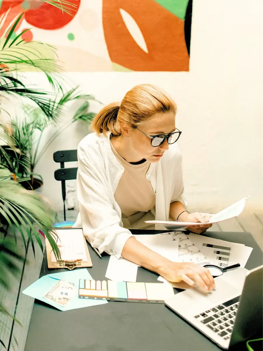Woman pausing at her desk representing someone who takes care of everyone around her and is ready to turn some of that care toward herself in the Your Relationship with YOU workshop