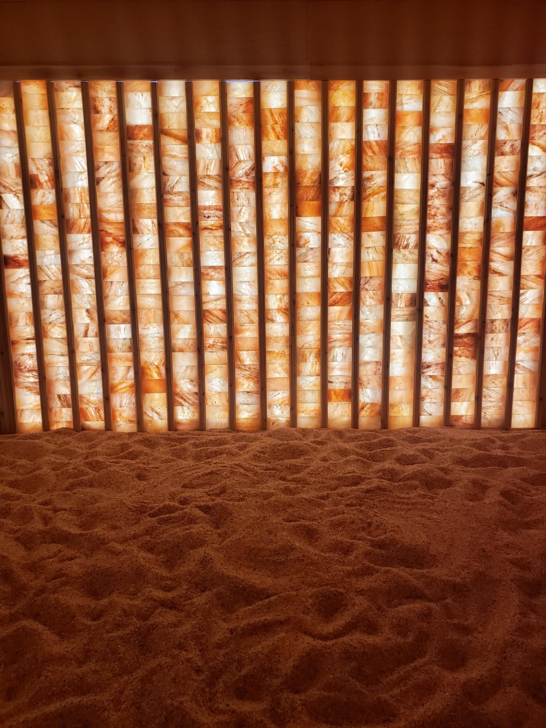 Himalayan salt wall glowing amber at Athena