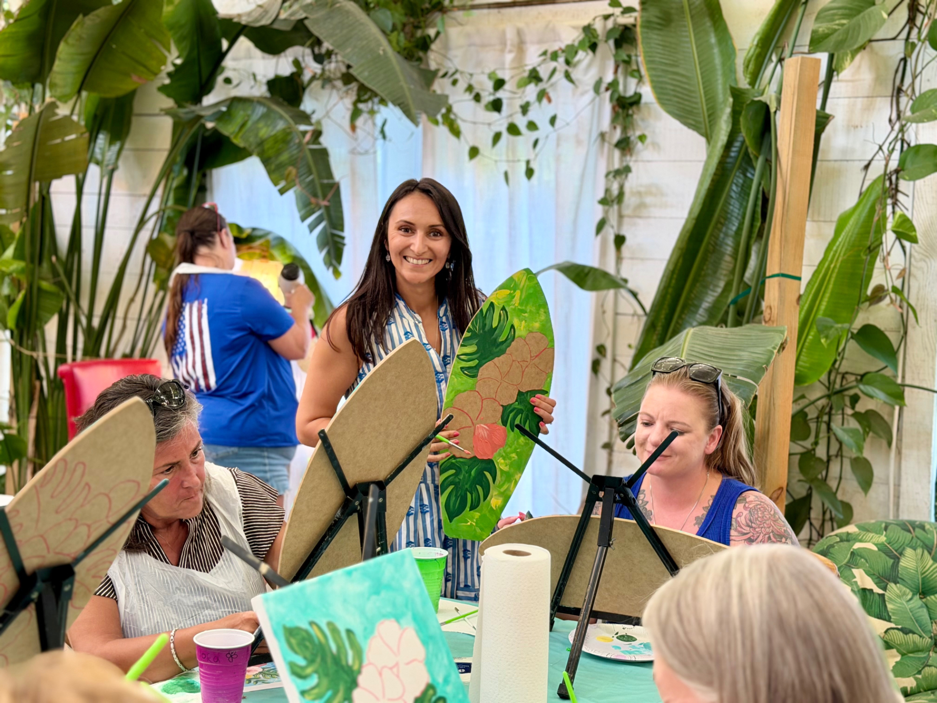 Nelli guiding guests at a Happy Cloud Art Studio painting event