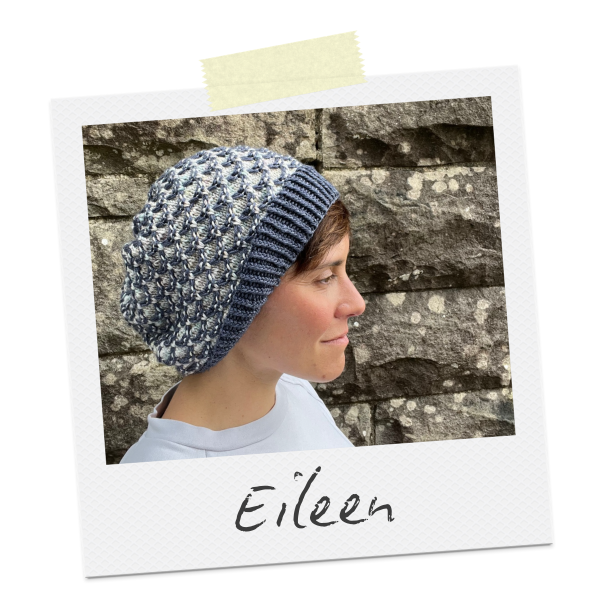 Polaroid with the word Eileen written on it. The photo shows a slouchy hat with a textural grey and blue slipped stitch design and twisted rib trim.