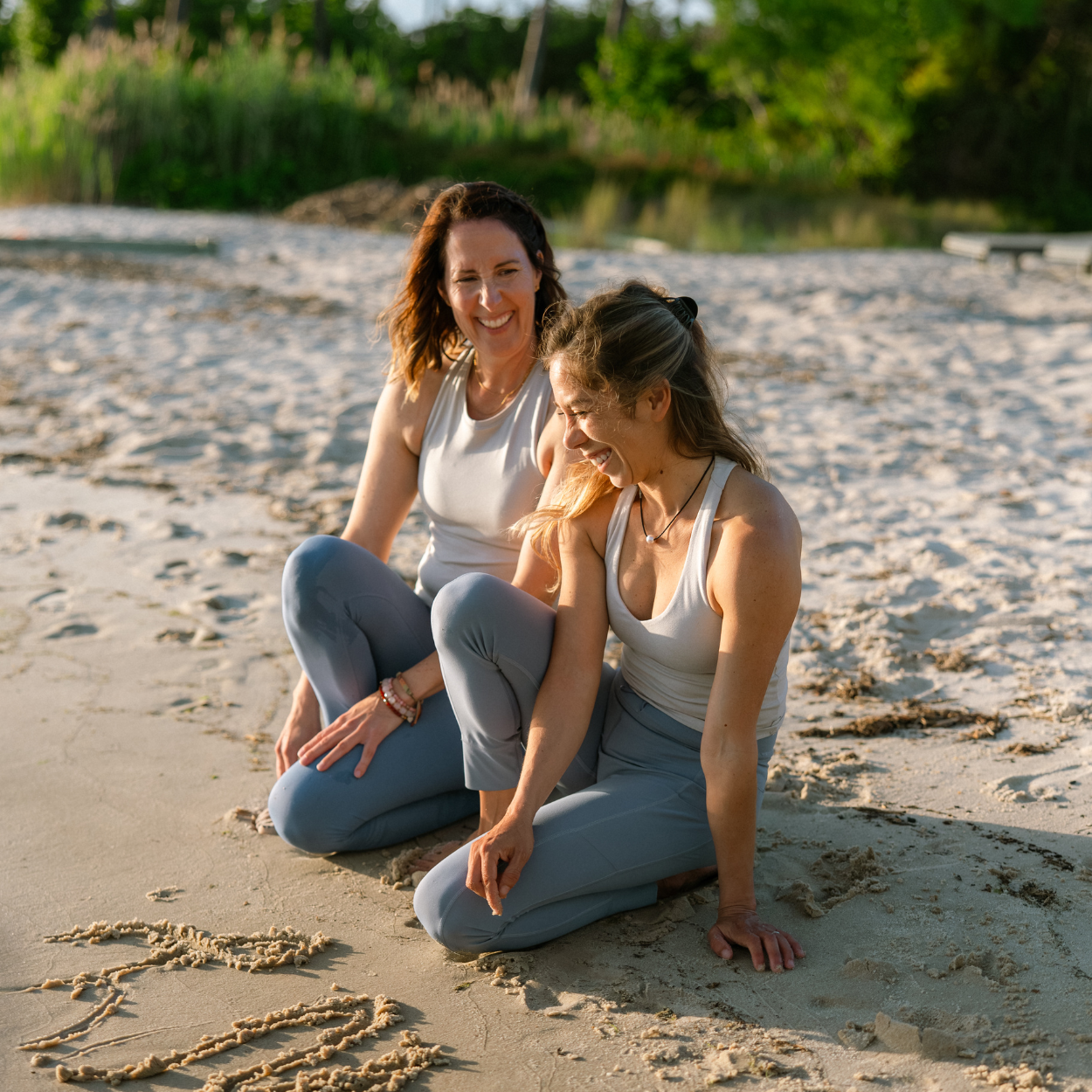 Flowing Wave Yoga instructors Julia and Lalai together outdoors