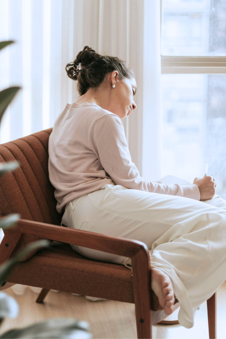 Woman sitting in quiet reflection, processing emotional healing