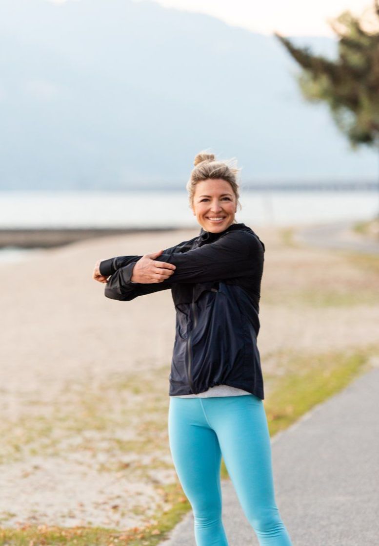 Kate stretching before workout on the beach