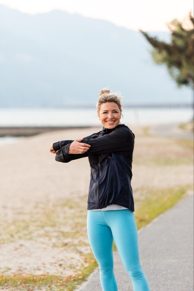 Kate stretching before workout on the beach