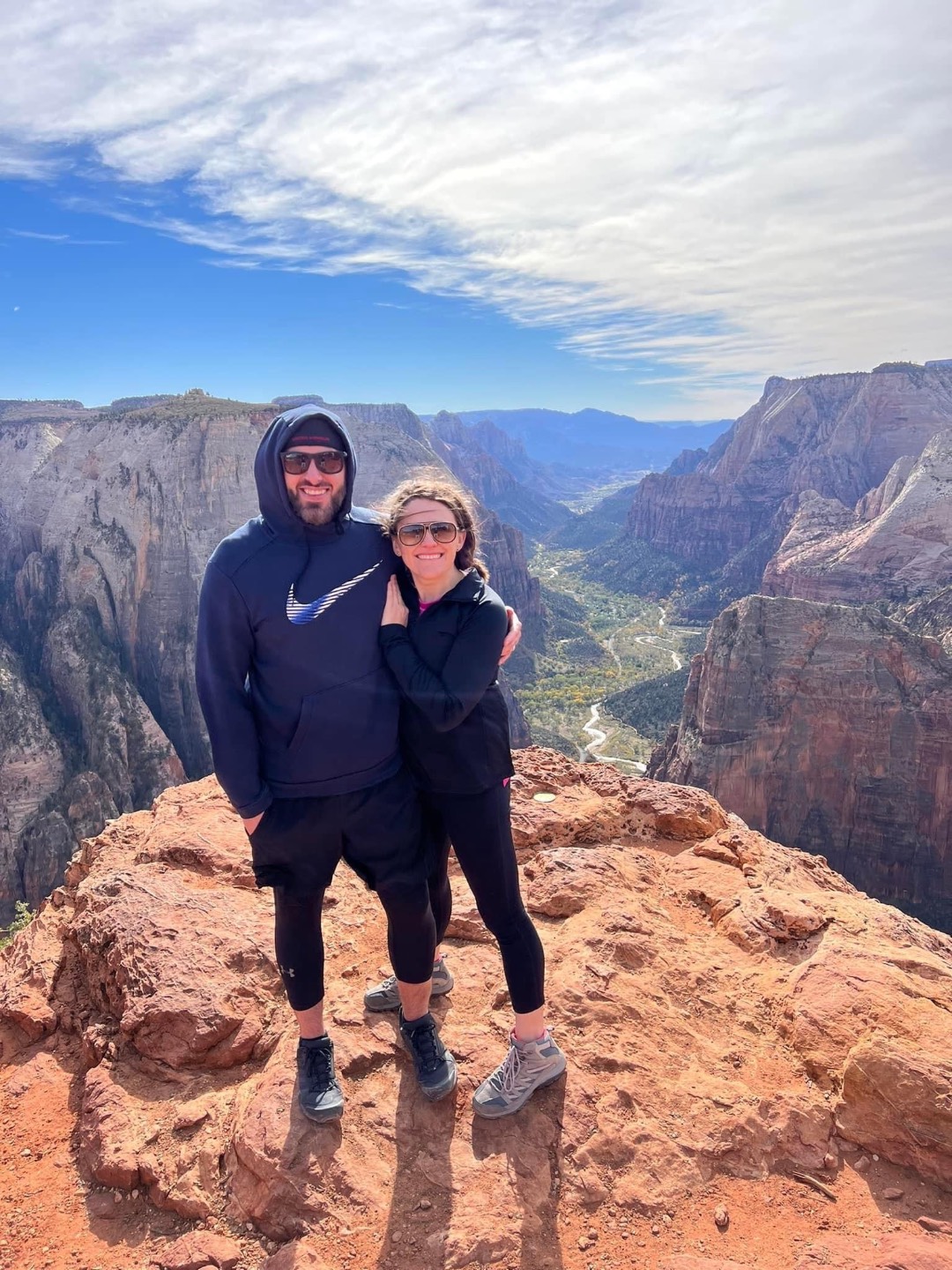 Chelsey and her husband at the top of a canyon hike in Zion
