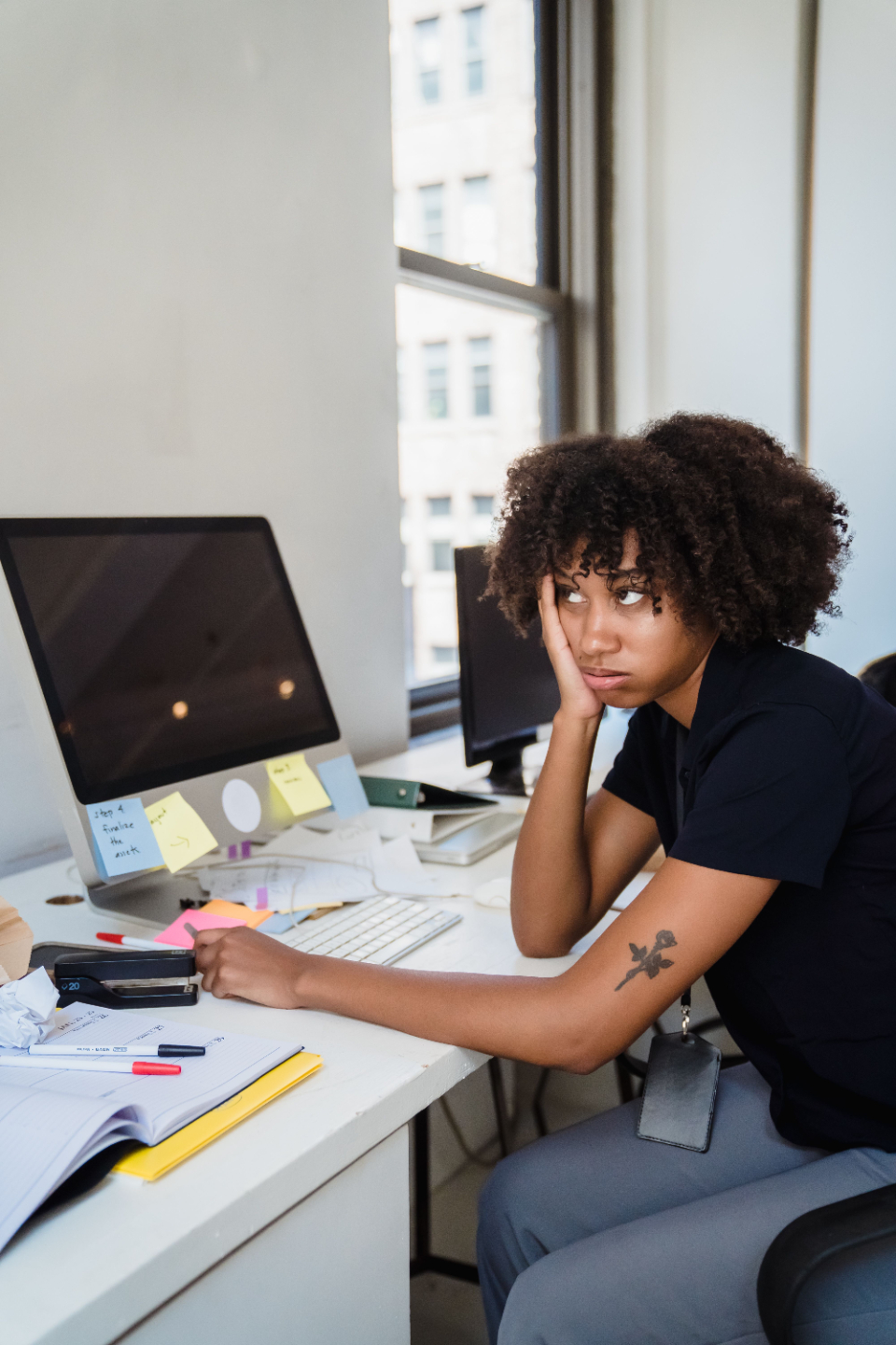 Woman struggles to focus working at her computer.