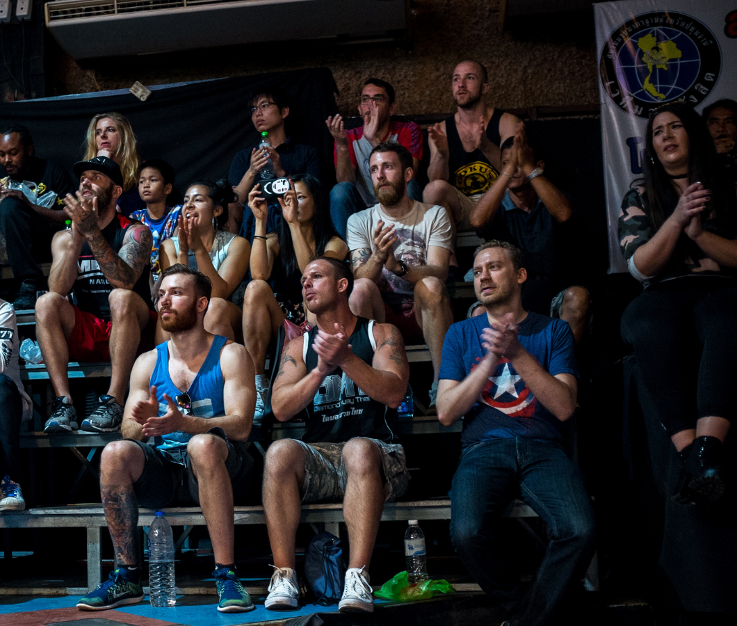 The group watching a Muay Thai fight from the stands