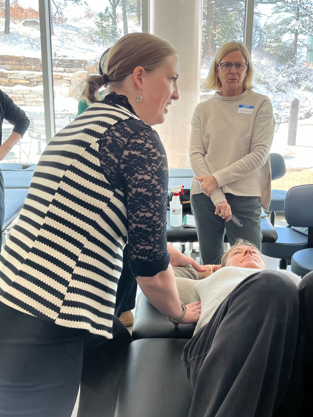 Occupational Therapist is seen performing interventions by using manipulation techniques around neck and shoulders. 