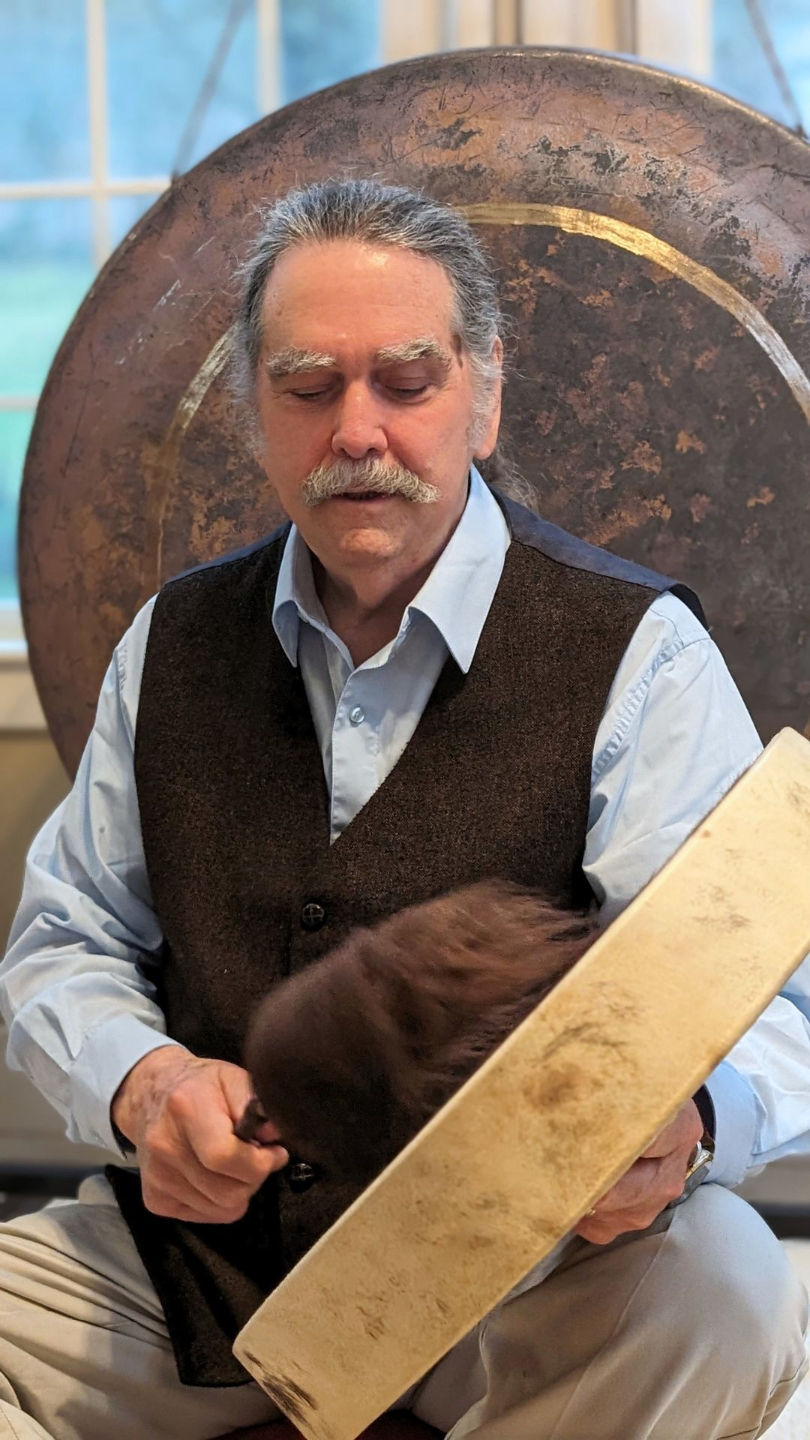 Zacciah Blackburn playing a hide drum
