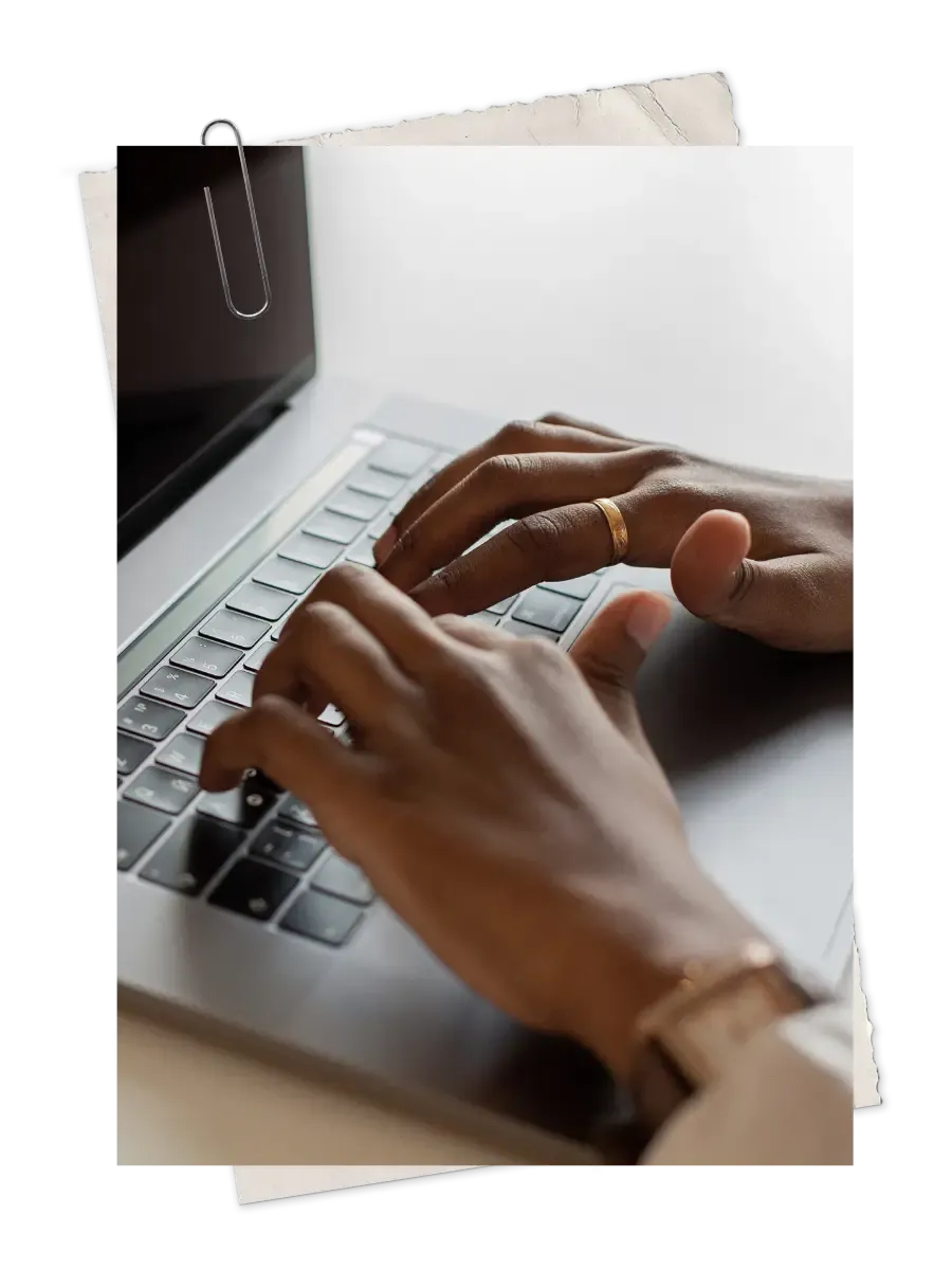 Close-up of Black hands typing on a laptop keyboard, representing browser-based access of Black lawyers to the Be The First BD Tracker