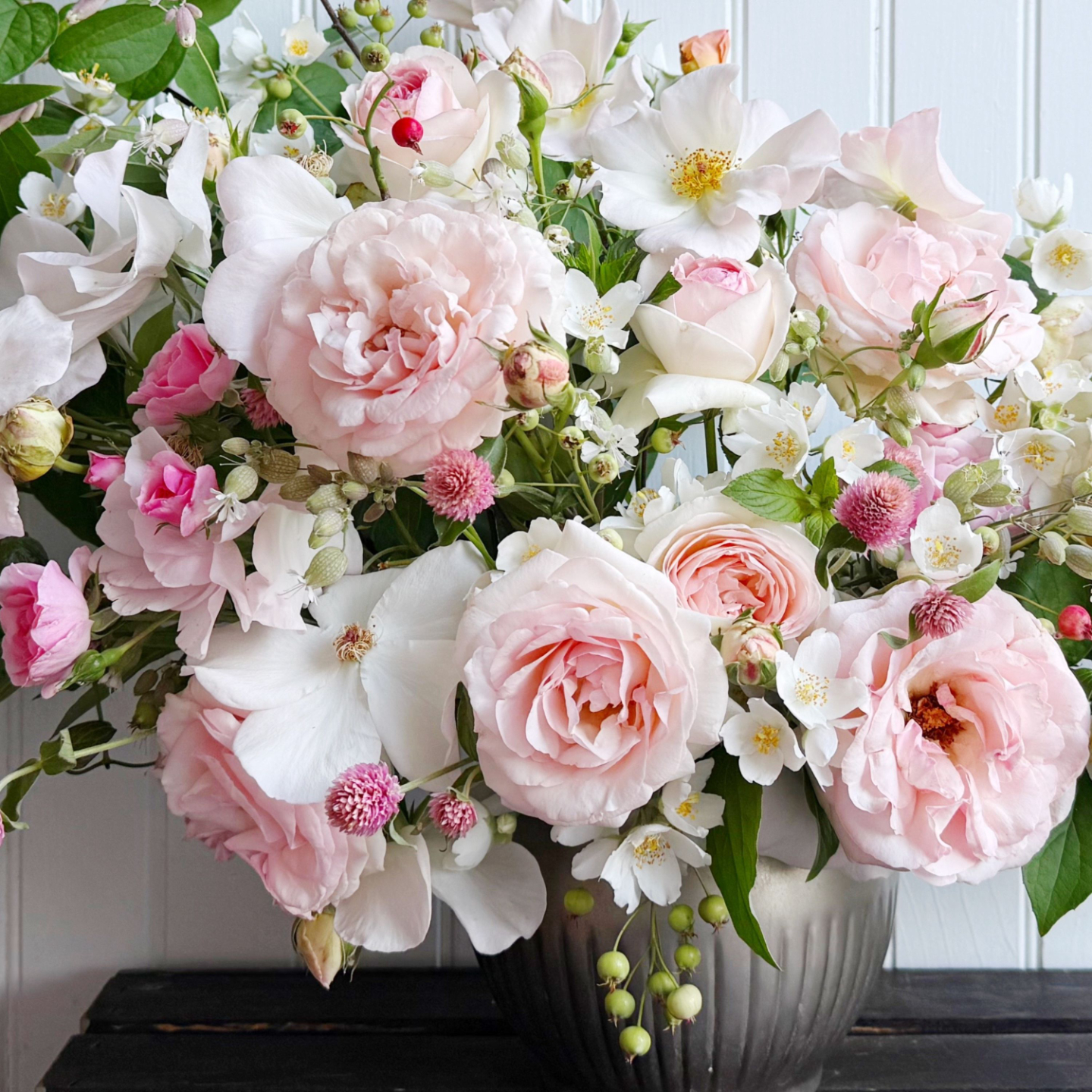 arrangement with roses, service berry and gomphrena