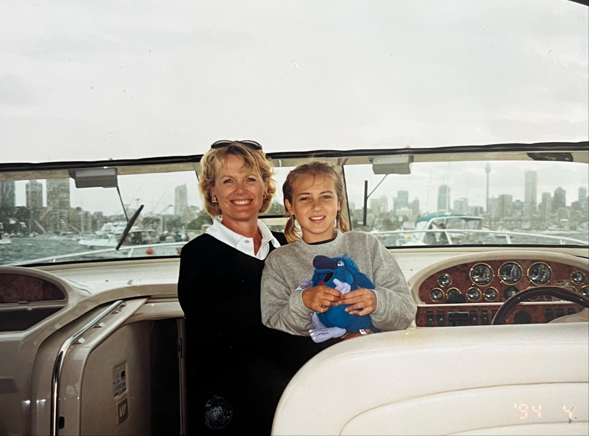 Old film style photo of a Mother and daughter smiling on a boat