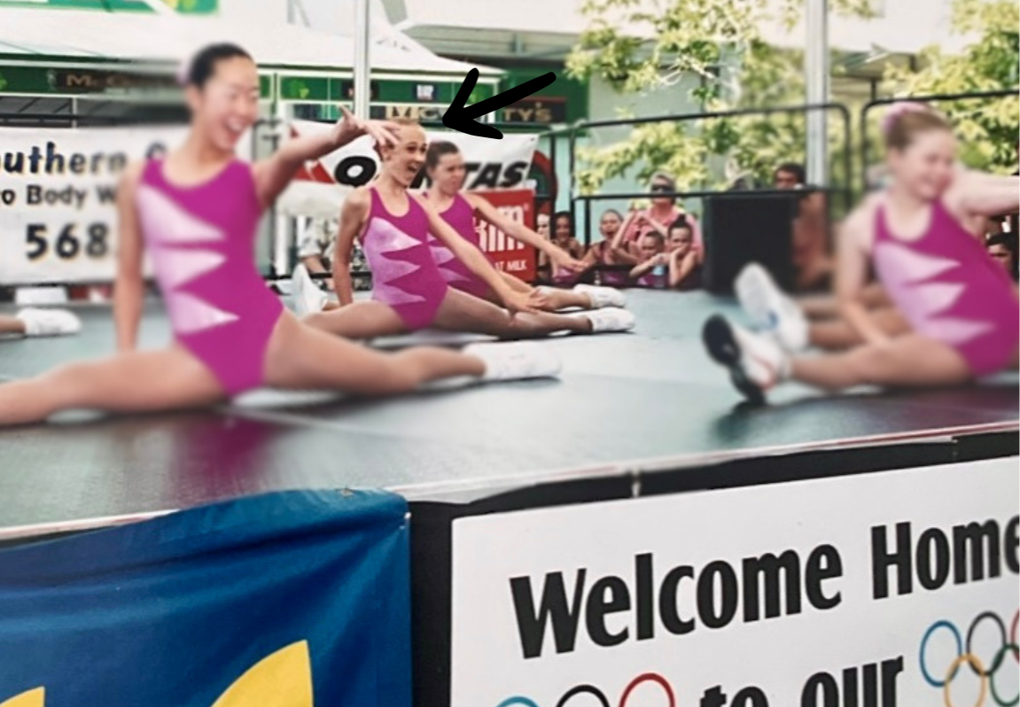 Young girls in pink leotards performing on a stage