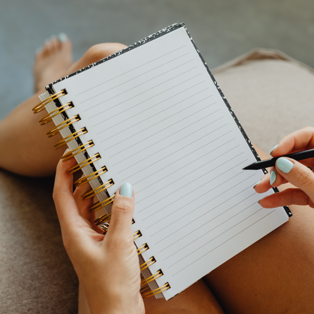 writing in a blank notebook
