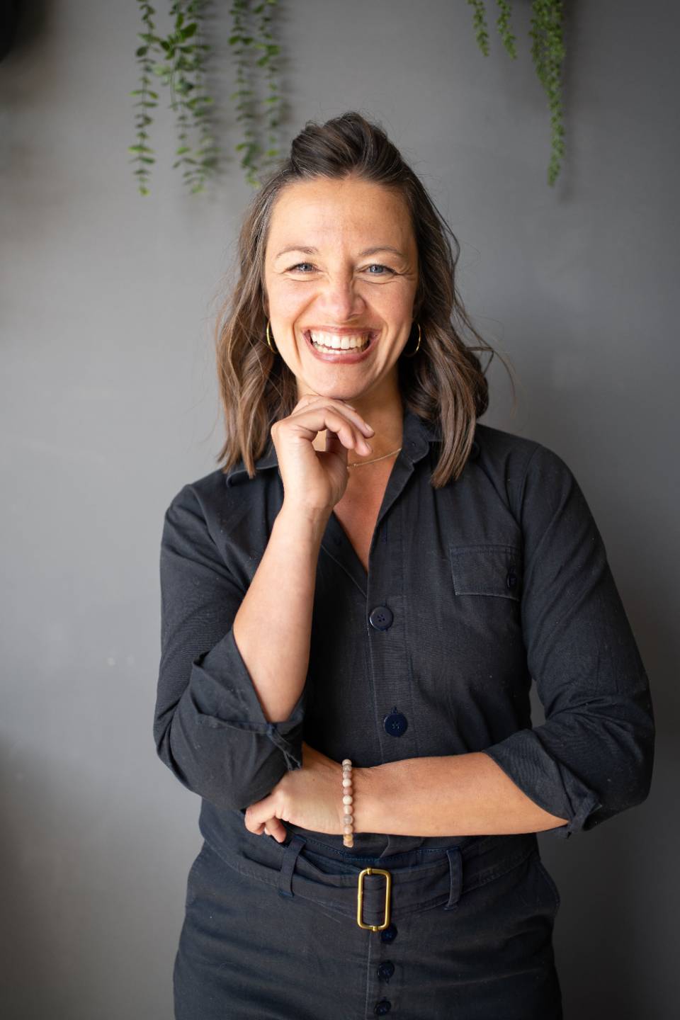Steffi Seefeld, somatic trauma-informed coach, seated and smiling at camera