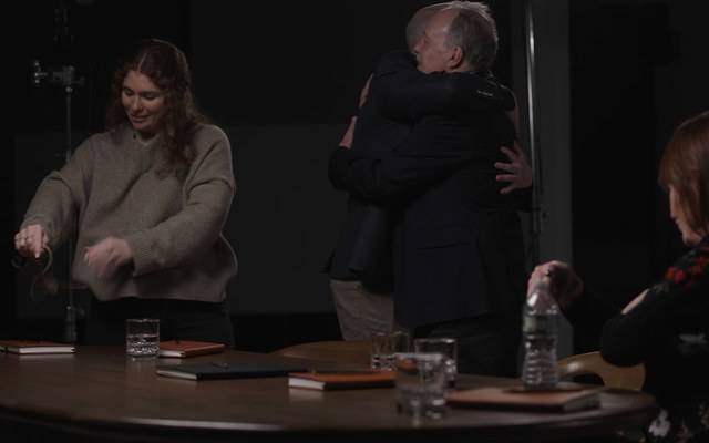 Andrew embracing a colleague after filming