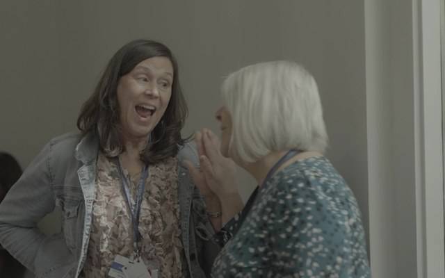 Two clinicians laughing at a live training