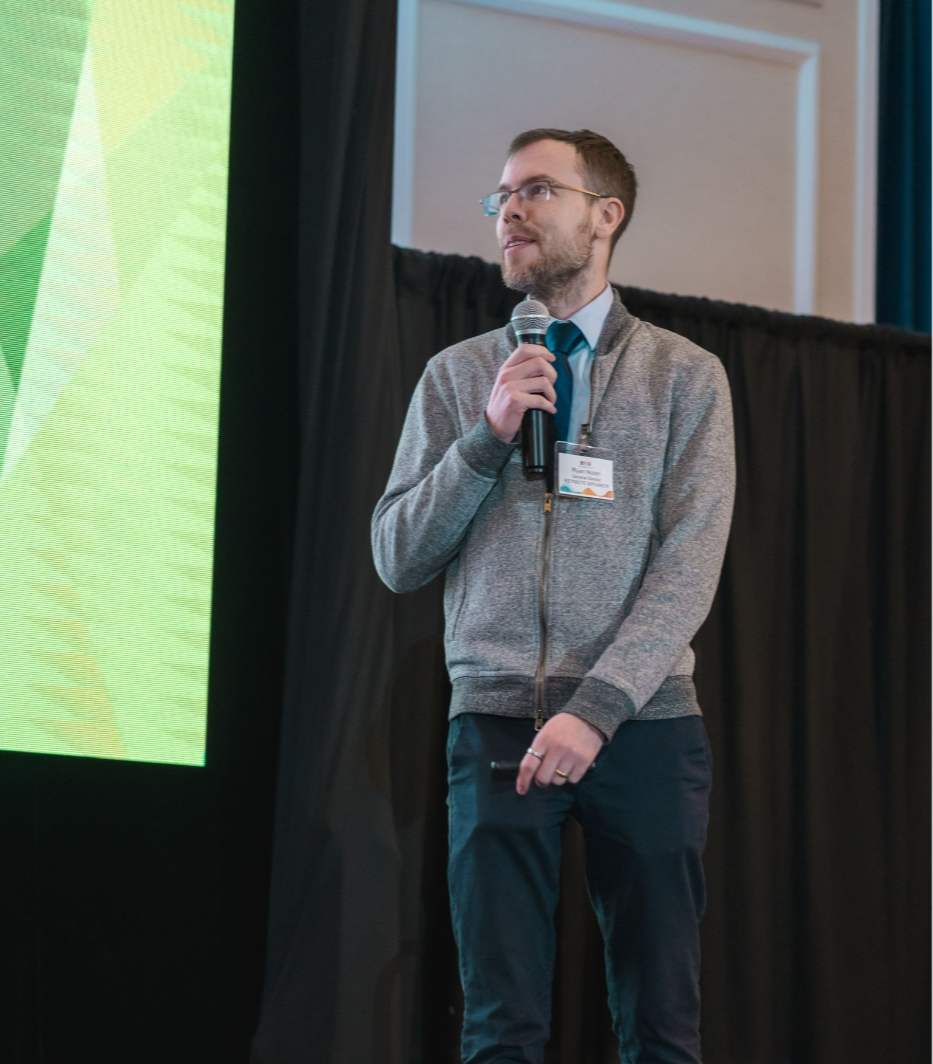 Dr. Ryan Nolan lecturing on stage
