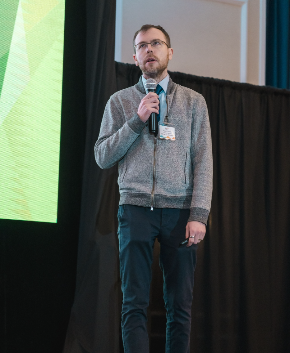 Dr. Ryan Nolan speaking on stage