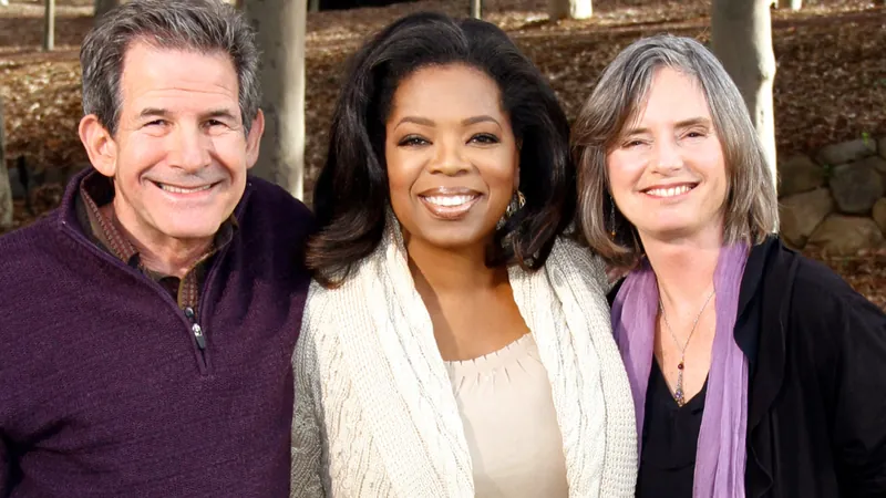 Gary Zukav and Linda Francis stand outdoors with Oprah Winfrey, all three smiling