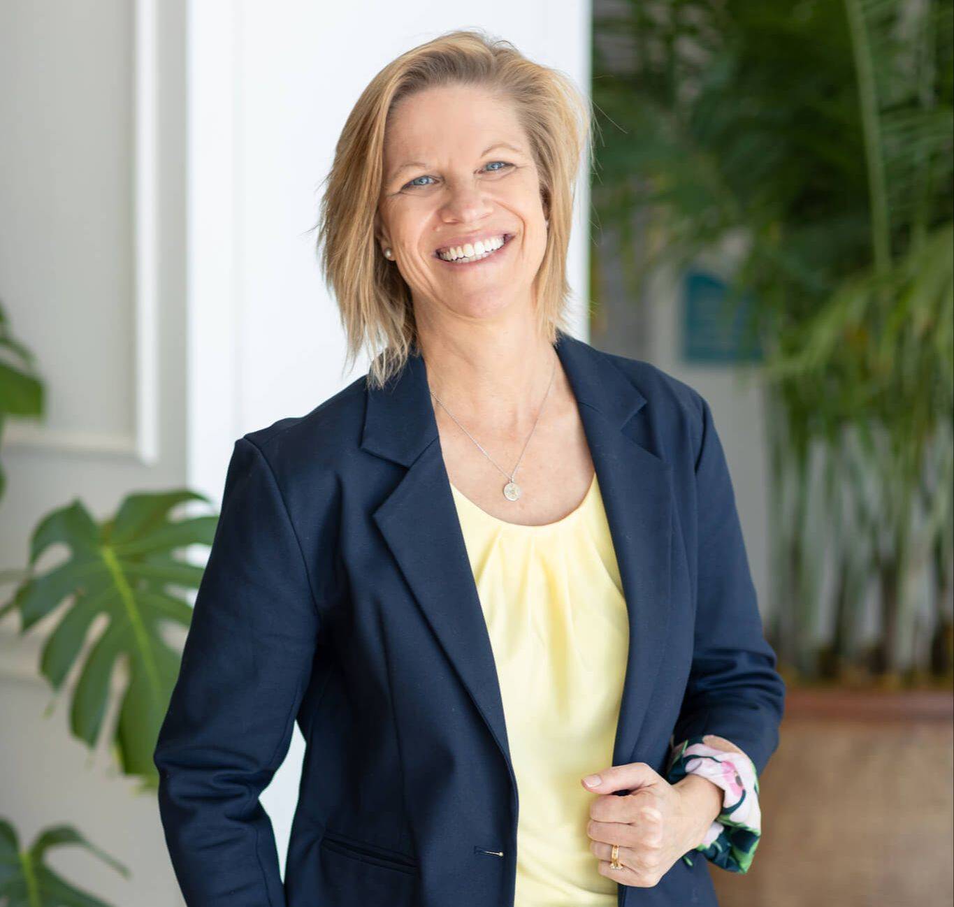 Shari Biery National Board Health and Wellness Coach looking over computer