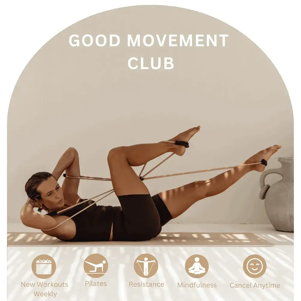 Woman working out on an exercise mat with a reformer band, stretching out her legs 