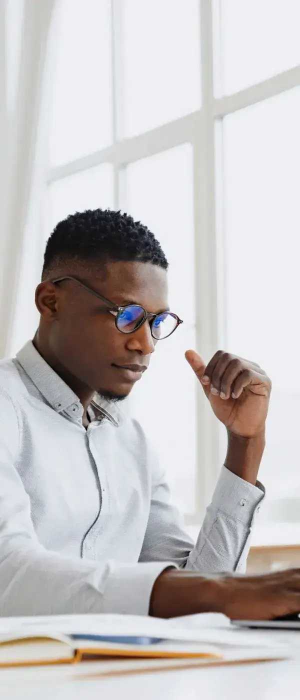 Black male lawyer thoughtfully reviewing his career strategy at his desk