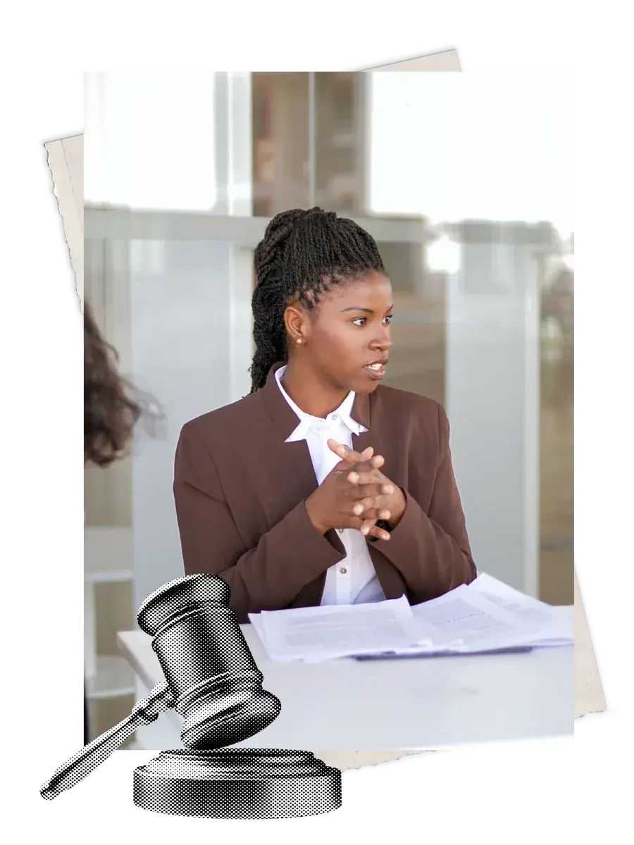 Black female lawyer discussing and sitting confidently with legal documents