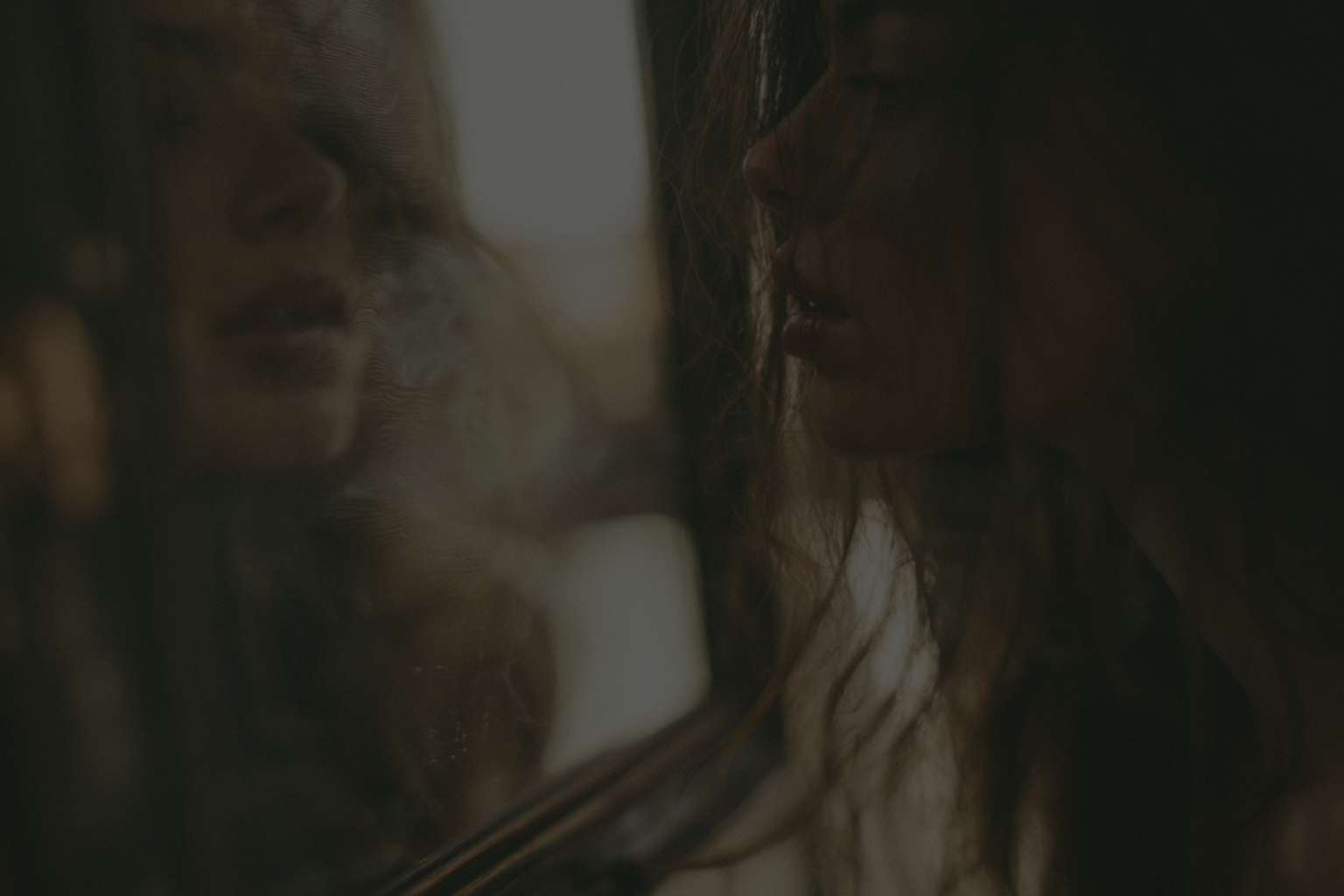 Woman facing her reflection, representing conscious and unconscious voice