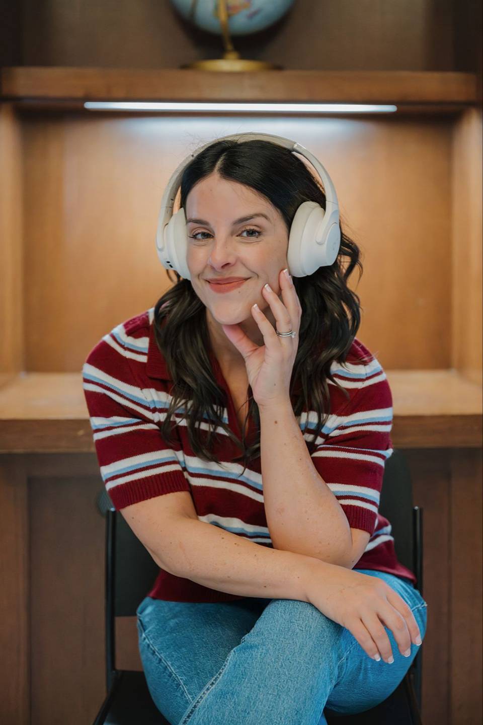 Julie Costa smiling in white over-ear headphones