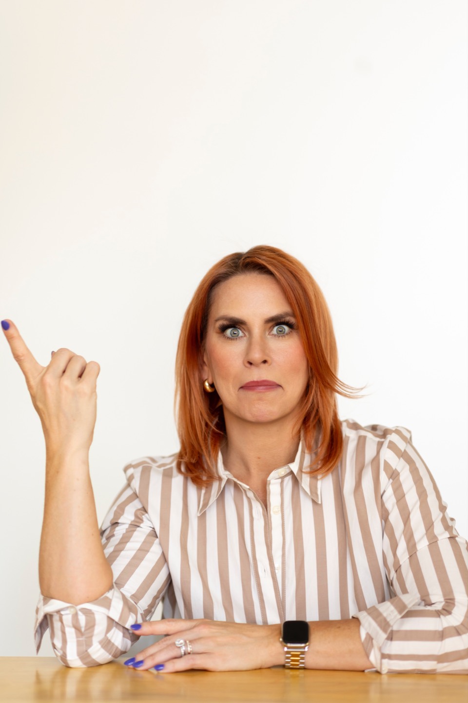 Portrait of a hiring expert pointing inward