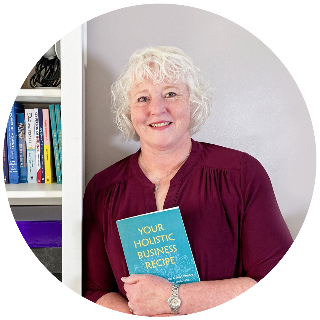 Helen Harding holding her book Your Holistic Business Recipe
