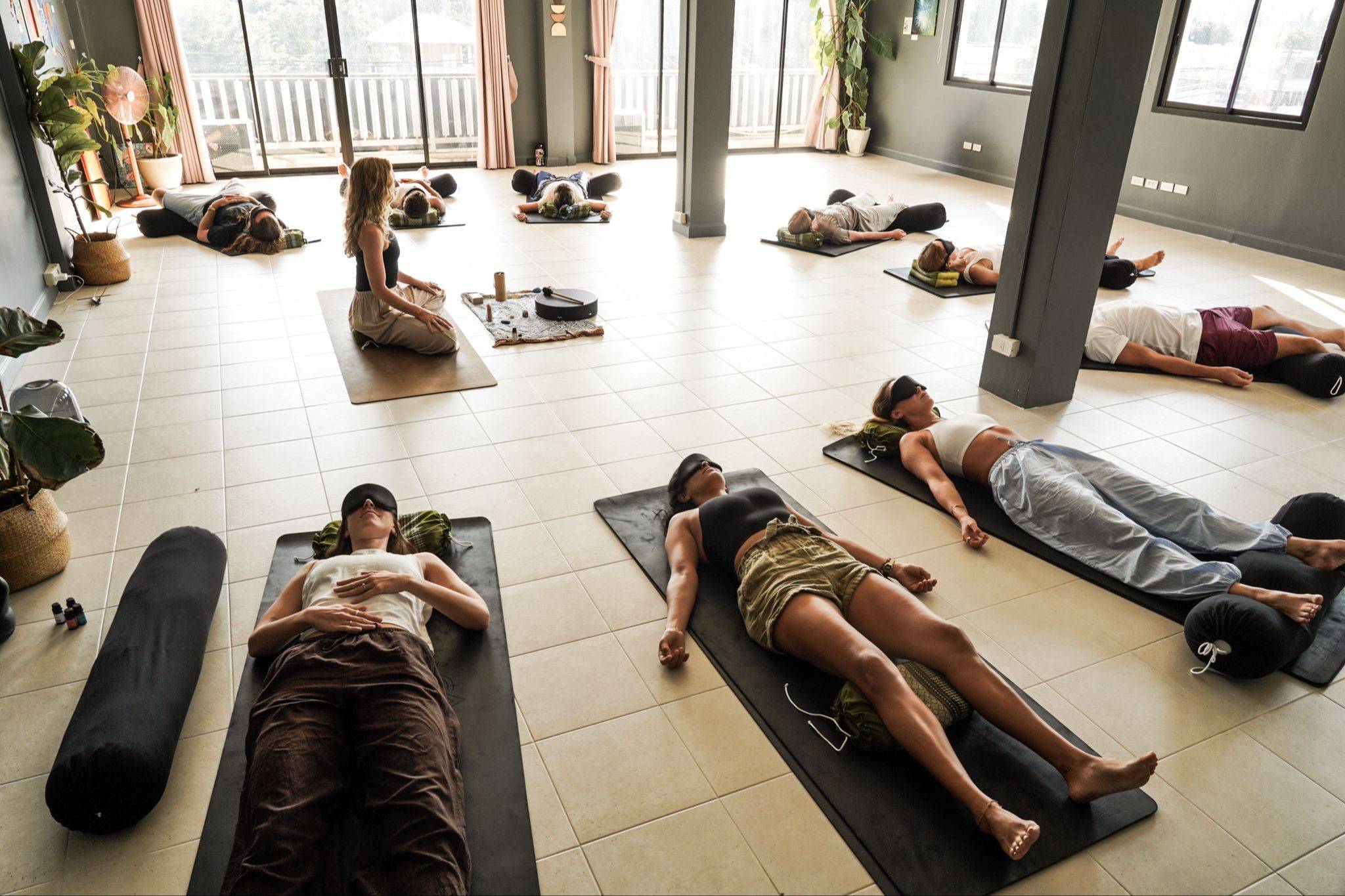 Breathwork facilitator training group lying on mats during a conscious connected breathwork journey