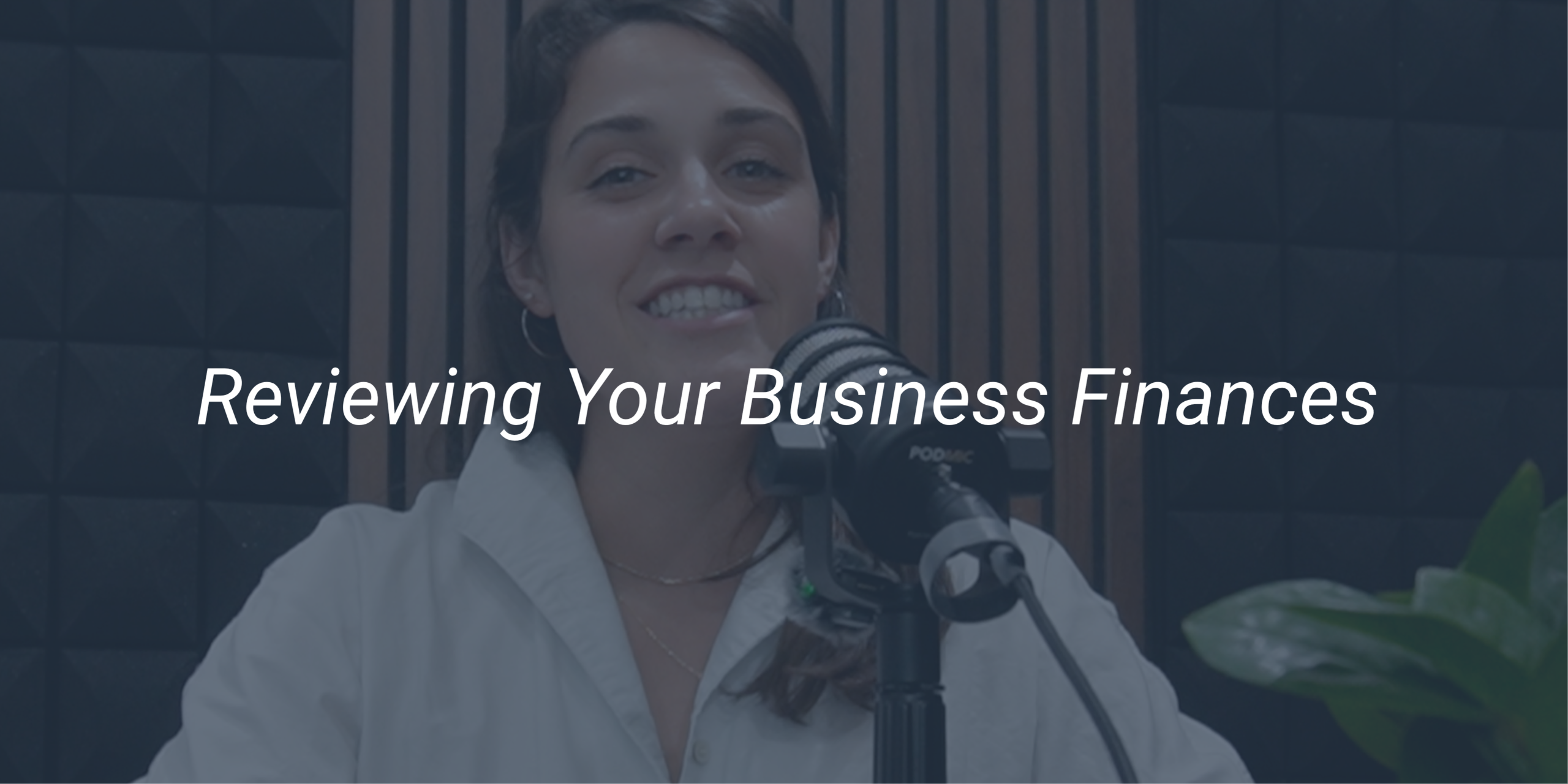 Katie Robinette smiling at a podcast microphone in the Evermore studio