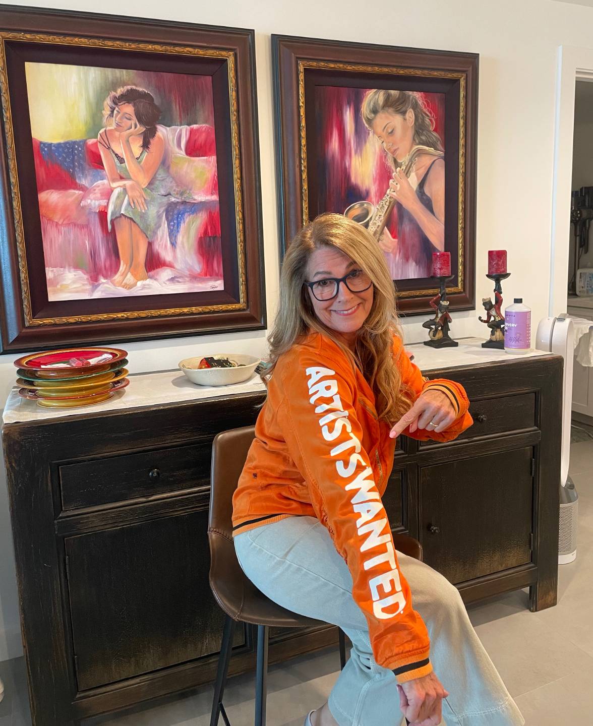 Pomm wearing a sweater that reads Artists Wanted